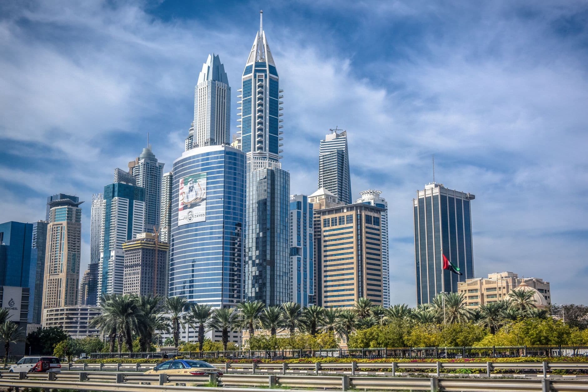 A vibrant view of the iconic Dubai skyline showcasing modern skyscrapers under a clear blue sky.