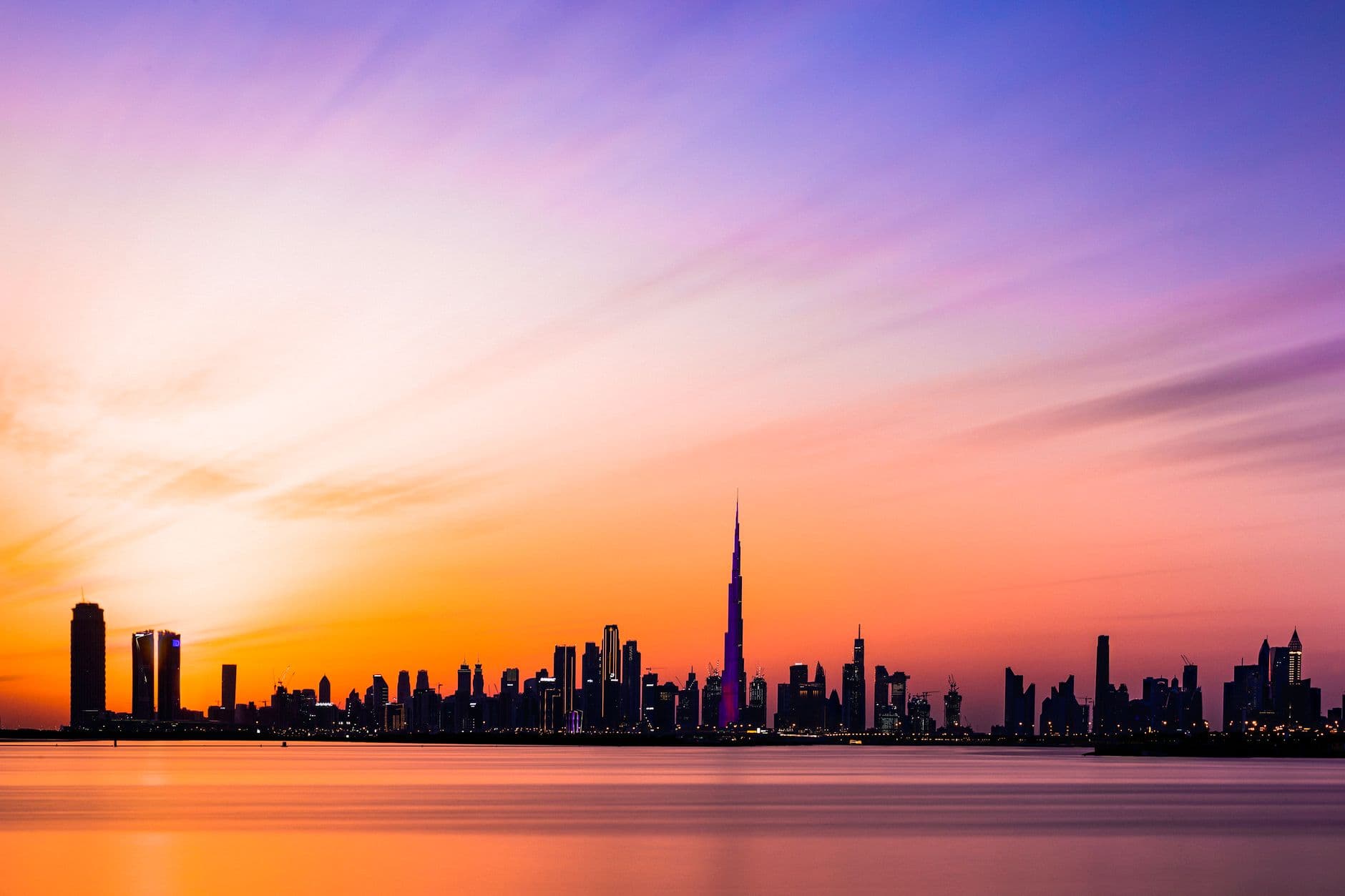 Beautiful view of the Dubai skyline featuring Burj Khalifa during a colorful sunset.