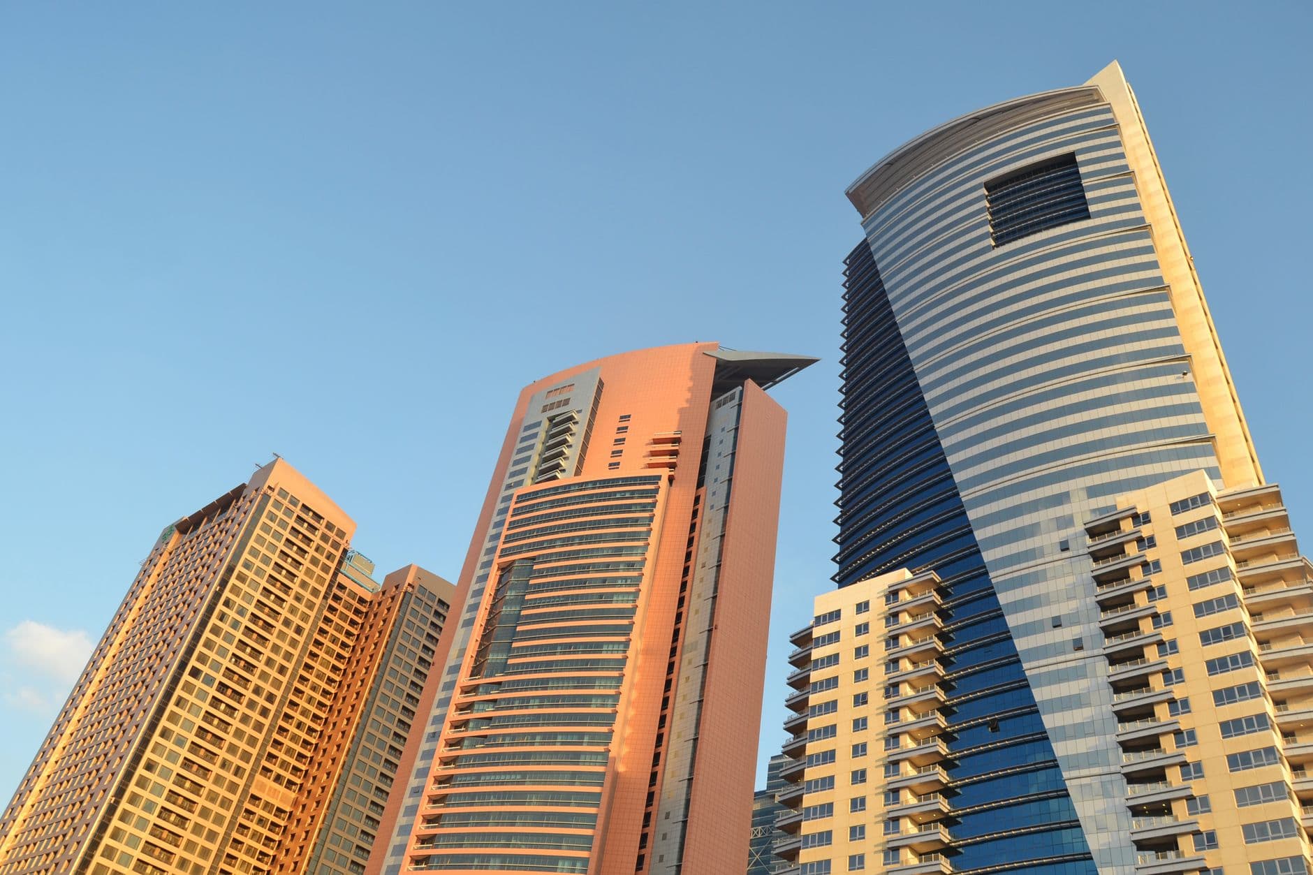 Stunning view of modern skyscrapers against a clear sky in Dubai, UAE, showcasing architectural marvels.