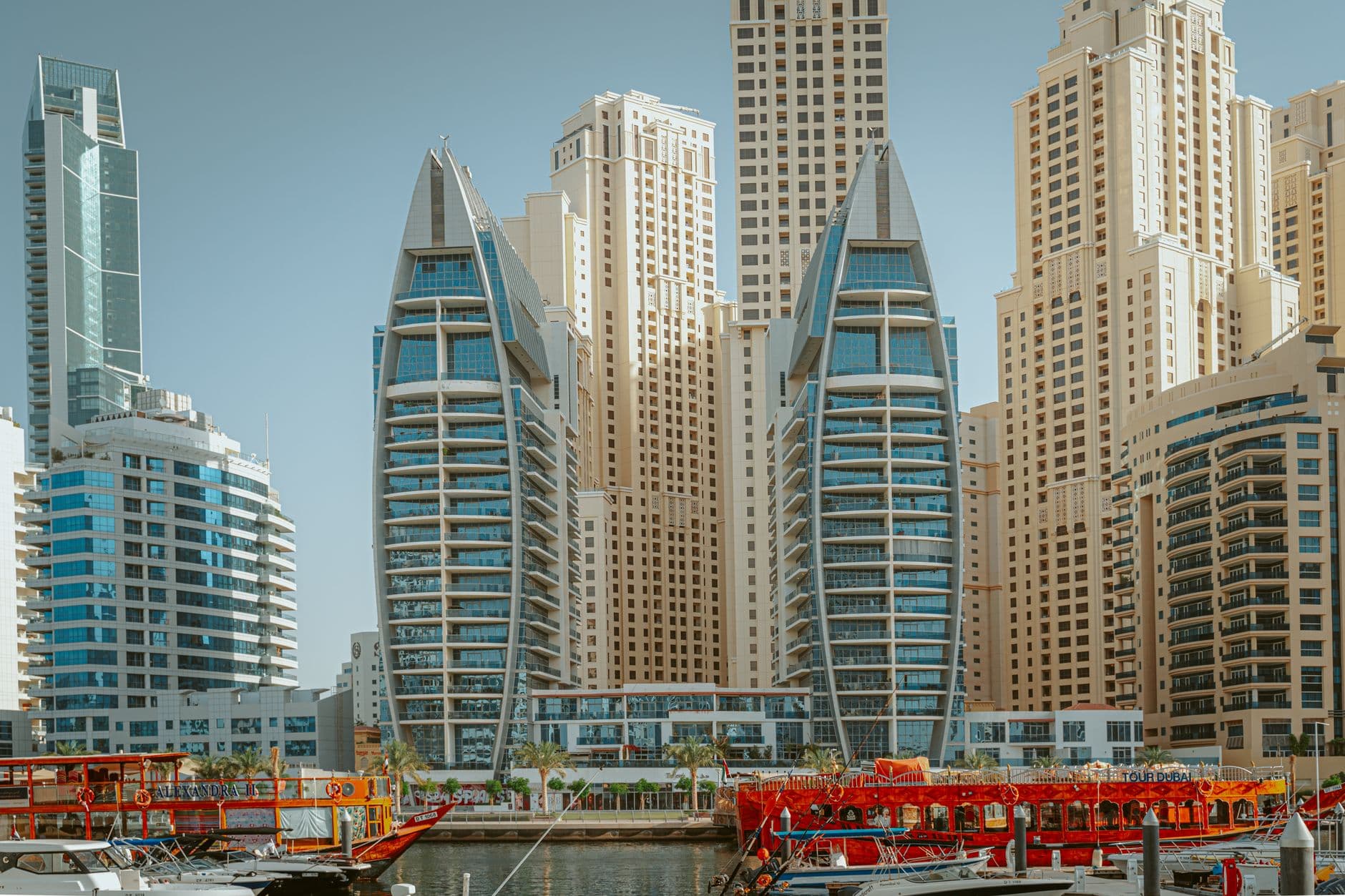 Stunning view of modern skyscrapers and yachts in Dubai Marina, UAE.